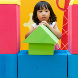 Kid playing with giant blocks